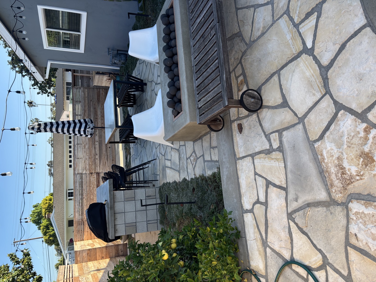 Finished flagstone patio and outdoor living space built by Legendary Landscaping in Orange County